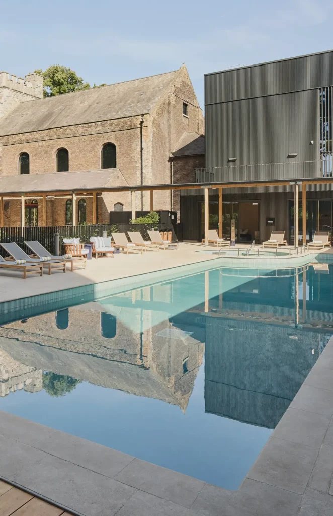 The pool area of The Wick, also known as The Resident's Club at The Brentford Project. The image shows the pool, outdoor area and surrounding buildings.