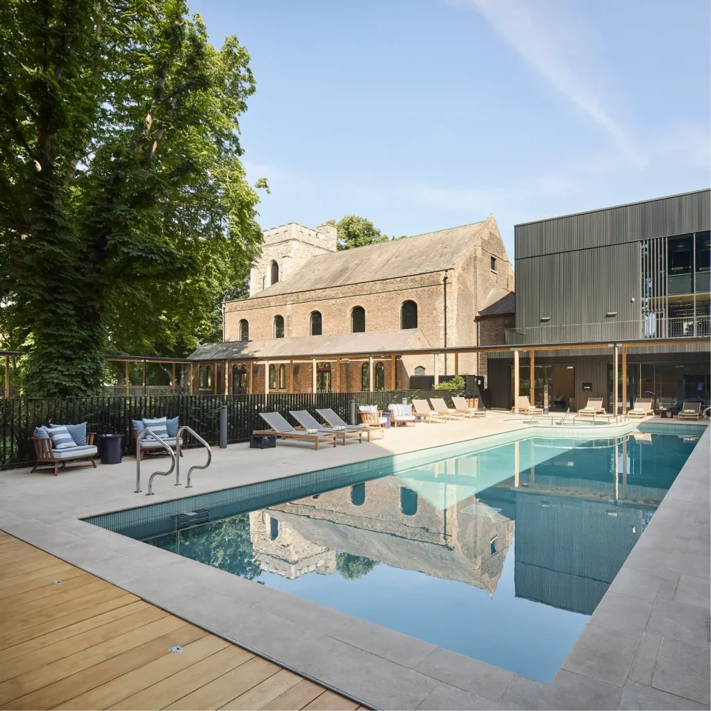 The pool area of The Wick, also known as The Resident's Club at The Brentford Project. The image shows the pool, outdoor area and surrounding buildings.